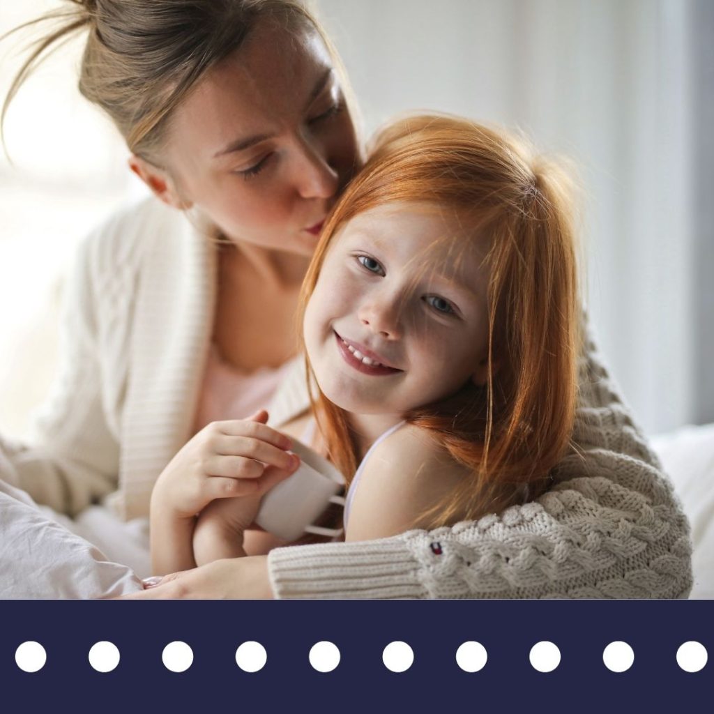 Woman hugging and kissing her child on the head