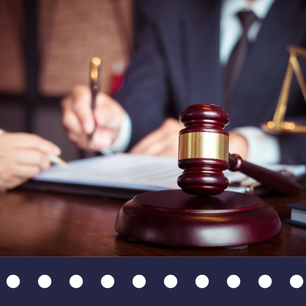 Legal professional in Wilmington NC reviewing evidence for a personal injury or catastrophic accident claim with a judge's gavel